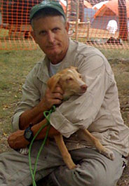 Humane Society International responder Lloyd Brown holds a dog in Haiti