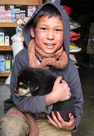 Child and puppy in Bhutan
