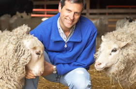 Farm Sanctuary President and Co-Founder Gene Baur with two sheep